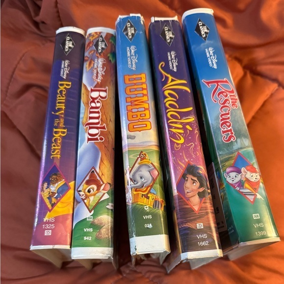 Spines of five Walt Disney Classics VHS tapes showing the black diamond banner repeated on each